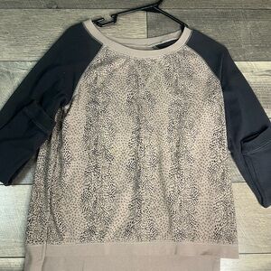 tan sweatshirt with grey sleeves, poppy seed design